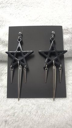 Looking for something with a witchy vibe? Then these black pentagram earrings are the right thing for you.  - Resin cast black pentagram, approximately 50 mm wide  - Buckles and studs are made of stainless steel, so they are suitable for those who are allergic to nickel  - Acrylic spike, 50 mm long  - Acrylic spikes, 24 mm long You can choose safety clips from stainless steel or silicone.  You can fit them into any outfit and these are some of the ideas: They will look great on a tight gothic dress, a wide grunge vest or a shirt. Complete your witchy Wiccan with these beautiful earrings.  I am at your service for all information.  Thank you for your interest in my work and support.  Follow me on the social networks listed below.  Facebook: www.facebook.com/KalitheaAlternativeAccessories  I Punk Style Star-shaped Metal Earrings, Black Star-shaped Metal Earrings, Black Earrings For Alternative Fashion, Black Pierced Earrings For Alternative Fashion, Gothic Black Nickel-free Plug Earrings, Nickel-free Gothic Black Plug Earrings, Edgy Star-shaped Pierced Earrings, Black Punk Earrings For Alternative Fashion, Black Metal Grunge Earrings