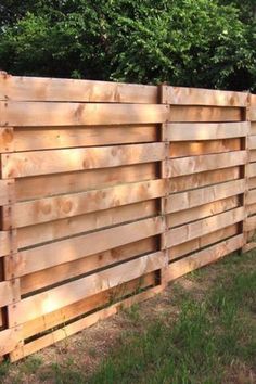 a wooden fence is shown in the grass