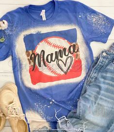 a t - shirt with the word mama on it next to some denim shorts and shoes