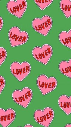 pink hearts with the word love spelled in red on a green background seamless pattern