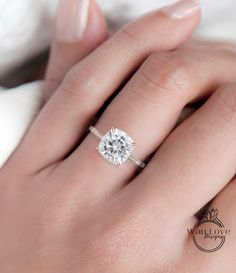 a woman's hand with a diamond ring on it