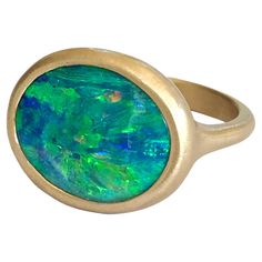 Dalben design 18k yellow gold satin finishing ring with a 7,4 carat bezel-set oval shape magnificent Queensland mine Australian boulder opal . The Australian Boulder Opal have deep blue and green spots. Ring size US 7 1/4 - EU 55 re-sizable to most finger sizes. Bezel setting dimension: width 17,8 mm, height 14,6 mm. The ring has been designed and handcrafted in our atelier in Italy Como with a rigorous quality workmanship . For a faster shipping service please choose "Buyer arranged shipping Fr Italy Como, Australian Boulder Opal, Gold Satin, Green Opal, Yellow Gold Ring, Boulder Opal, Opal Rings, Yellow Gold Rings, Bezel Setting