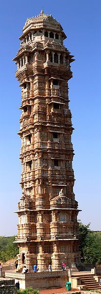 the tall tower has many windows on it's sides and is made out of wood