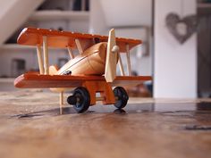 a toy airplane sitting on top of a wooden table