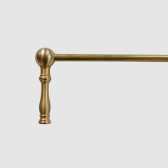 an antique brass pull handle on a white background