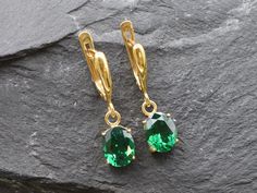 Gold Emerald Earrings set with a Created Emerald in a flawless diamond cut & clarity, deep green color, at 10x8mm, 6 Carats a pair. Dangling Earrings made of Gold Vermeil ☞ thickest 18k Gold Plating on Solid 925 Sterling Silver ☞ made to last. Click here for ☞ Matching RingClick here for ☞ Matching Pendant Details:♥ Created Emerald in a flawless clarity and deep green color,♥ Garnet: 10x8mm, 3 Ct, Diamond cut♥ Lever Back Closure - "English Lock"♥ Height 17mm, Width 8mm♥ 18k Gold VermeilSKU 2828( Green Teardrop Earrings With Prong Setting, Classic Green Diamond Cut Earrings, Formal Green Diamond Cut Earrings, Emerald Earrings With Diamond Cut For Gift, Emerald Diamond Cut Earrings Gift, Green Oval Earrings For Formal Occasions, Emerald Oval Earrings For May Birthstone, Oval Emerald Earrings For May Birthstone, Oval Emerald Earrings With Prong Setting