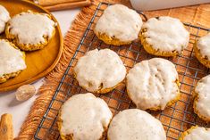 there are some cookies that have been frosted with white icing on the cooling rack