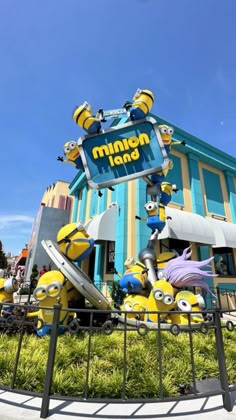 the minion land sign is in front of a building with many minions on it