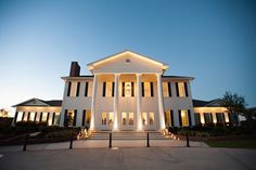 a large white house lit up at night