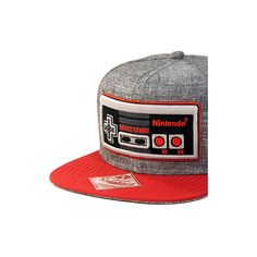 This Nintendo Hat features a large, high quality embroidered Classic NES Nintendo controller on front of a grey/red hat cap. The embroidery is raised and all this is on an Original Snapback brand hat. Great for Men, Women or Teens this one size fits most adjustable cap has a snapback with multiple sizing options that truly makes it One Size FIts Most OSFM. It is the great gift for any Nintendo fan. Gray Baseball Cap With Logo Patch, Gray Hat With Embroidered Logo For Streetwear, Gray Flat Bill Baseball Cap With Embroidered Logo, Gray Cotton Snapback Hat With Flat Bill, Gray Snapback Baseball Cap With Embroidered Logo, Gray Cotton Snapback Hat, Gray Cotton Flat Brim Baseball Cap, Gray Cap With Embroidered Logo, Gray Snapback Hat With Embroidered Logo