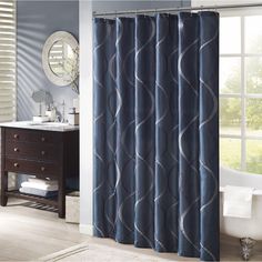 a blue shower curtain in a bathroom