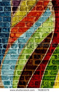 an abstract brick wall painted with multicolored stripes and swirls in the center