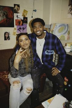 a man sitting next to a woman on top of a couch