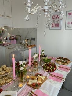 a table is set with food and candles for a valentine's day dinner or brunch