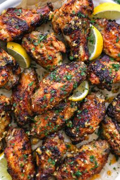 grilled chicken with lemons and herbs on a plate