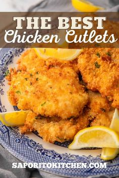 the best chicken cutlets on a plate with lemon wedges