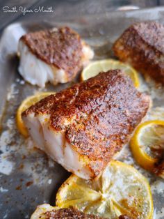 some fish with lemon slices and seasoning on it