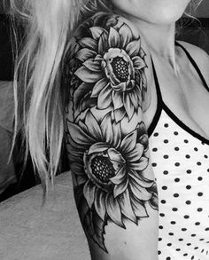 a woman with a sunflower tattoo on her arm and shoulder is posing for the camera