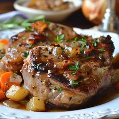 some meat and vegetables on a white plate