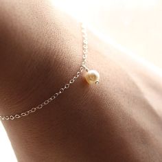 "The most simple & delicate everyday bracelet. A dainty Swarovski crystal light cream pearl (6mm) floats from the most dainty & shimmering sterling silver chain. Bracelet is completed with a round spring clasp. ♥Also available in gold fill: https://www.etsy.com/listing/104812683/dainty-everyday-gold-pearl-bracelet ★★Need help with your bracelet size? Please measure your wrist, and add 1/2 - 3/4 of an inch for a comfortable fit! ♥Your purchase will come thoughtfully packaged and ready for Classic Sterling Silver Charm Bracelet For Wedding, Dainty Sterling Silver Pearl Bracelet, Dainty Hypoallergenic Charm Bracelet For Weddings, Sterling Silver Round Charm Bracelet For Wedding, Dainty Silver Charm Bracelet For Bridesmaid Gift, Classic Bracelet Jewelry For Bridesmaid Gift, Elegant Tiny Silver Jewelry, Delicate Hypoallergenic Charm Bracelet, Adjustable Delicate Sterling Silver Bracelet