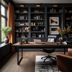 a home office with black bookcases, leather chairs and a wooden desk in front of a window