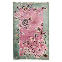 a pink and green rug with flowers on it