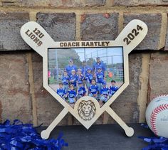 a group of baseball players standing in front of a wall with their bats and ball