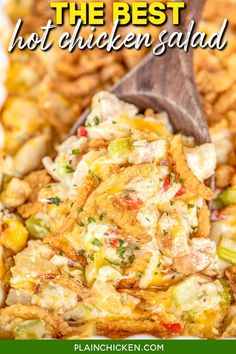 a close up of a spoon in a casserole dish with corn and vegetables