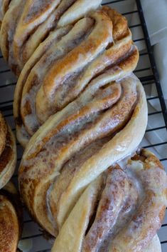 several cinnamon rolls are cooling on a rack