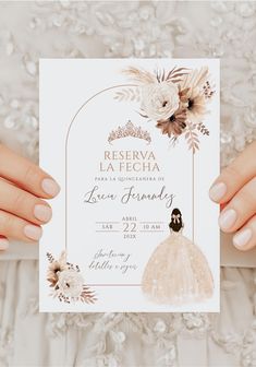 two hands holding up a white wedding card with flowers on the front and back side