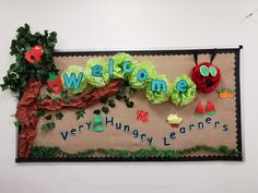 a bulletin board with the words welcome to very hungry learners and an apple tree