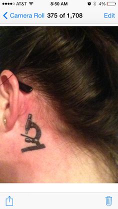 a woman with a camera tattoo on her ear