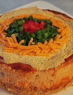 a round cake with cheese and vegetables on top