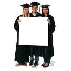 three people in graduation caps and gowns holding up a white board