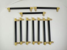 six black and gold handles are shown in this image