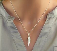 This unique pendant is made with sterling silver cover up with a clear to prevent tarnishing. This represent a unique and beautiful combination of a leaf and a feather. It is a very original design drawn and made by the artist.  This pendant is very light and delicat and will please people who enjoy wearing small but yet atistic jewelry. A perfect present  for birthday(anniversary), Mother's Days, wedding, Christmas or to offer itself to oneself! dimensions : 3.5 cm x 0.7 cm matching earring : https://www.etsy.com/ca/listing/235545250/silver-leaf-earring-silver-feather?ref=shop_home_active_21 return to my shop : https://www.etsy.com/ca/shop/stephanielemelin?ref=listing-shop2-all-items-count#items Silver Sterling Silver Necklaces With Feathers, Silver Feathered Sterling Silver Necklaces, Silver Feather Pendant Jewelry, Elegant Sterling Silver Feather Jewelry, Leaf Earrings Silver, Art Nouveau Ring, Delicate Pendant, Moon And Star Ring, Silver Necklaces Women