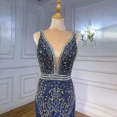 a dress is displayed on a mannequin in front of a chandelier