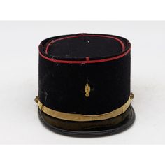 A rare French Military Academy Officer's hat or cap from the 1970s. These special and unique hats are part of the uniform of students studying to become officers in the French Military. This cap features a black leather brim on black felt with a red braid around the top, a gold band across the brim with gold studs, and a gold emblem on the front. 6.25"w x 10"d x 4.25"h. Wear consistent with age and use. Black Ceremonial Costume Hat With Curved Brim, Ceremonial Black Costume Hat With Curved Brim, Black Hat With Short Brim For Ceremonial Use, Black Ceremonial Hat With Short Brim, Black Short Brim Hat For Ceremonial Use, Black Short Brim Hat For Ceremonial Occasion, Black Brimmed Hat For Ceremonial Occasions, Black Short Brim Ceremonial Hat, Military Style Hat With Curved Brim