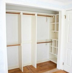 an empty walk in closet with wooden floors and white walls, open shelving unit