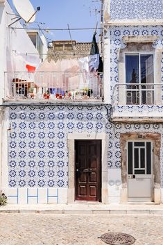 an old building with blue and white tiles on it