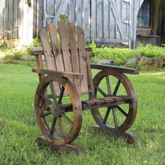 an old wooden wheel chair sitting in the grass