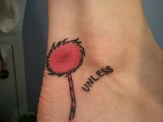 a pink flower with the word unless tattooed on it's side wrist and foot