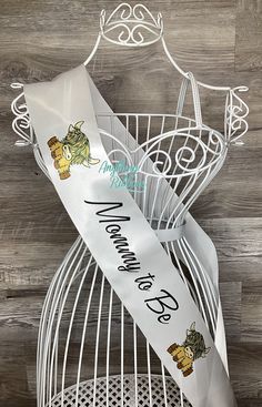 a white ribbon with winnie the pooh on it sitting in a birdcage