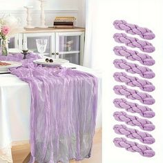 there is a table with purple cloths on it and plates in front of the table