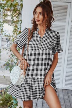 Our Genista Dress comes in a black & white tone check print. It features a v neckline and ruffle hem short sleeves for a relaxed comfortable fit. This gingham mini pairs beautifully with our heels or sandals for a fun casual look! Size Guide: Chloé is 5’7” tall, and has a 32.88” bust, 25.59” waist, & 36.2” hips. She is wearing a S / US 4 / AU 8. This dress is true to size. Material: 50% Viscose, 50% Polyester. Feature: Mini length. Relaxed fit. V neckline. Short sleeves. Maternity friendly. Plea Long Summer Dresses Maxi, Summer Plaid, Outfits Dresses, Mini Sundress, Festival Tops, Dresses Ideas, Summer Party Dress, Prom Dresses Long With Sleeves, Plaid Shorts