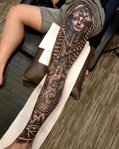 a person with a tattoo on their arm and leg is sitting in front of the camera