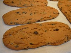 several cookies are lined up on a baking sheet and ready to be baked in the oven