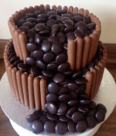 there is a chocolate cake with lots of chocolate candies on the top of it