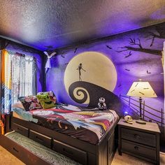 a bedroom decorated in black and purple with a bed that has a halloween scene painted on the wall