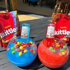 three different types of gummy bears on a picnic table next to two bags of littles